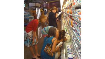 Participants try to find a food with the most calcium during a treasure hunt at a local grocery store