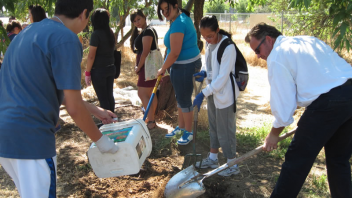 High school students and a program coordinator helped prepare soil for future planting in a CNS educational garden