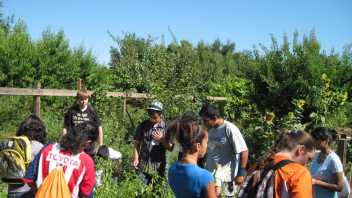 High school students learned about the different plants that are growing in an educational garden