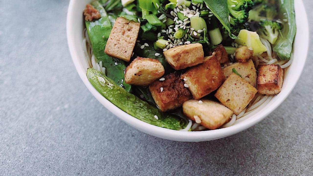 bowl of cooked tofu, greens, and rice