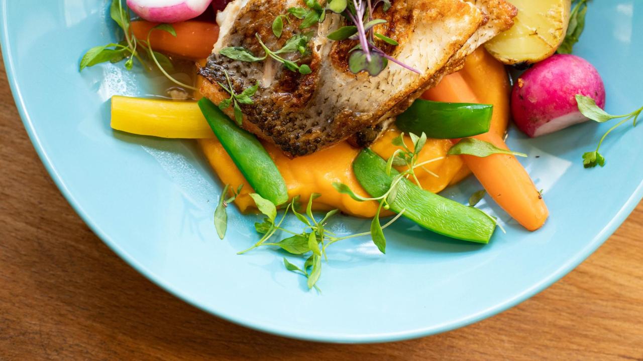 a plate of fish and vegetables