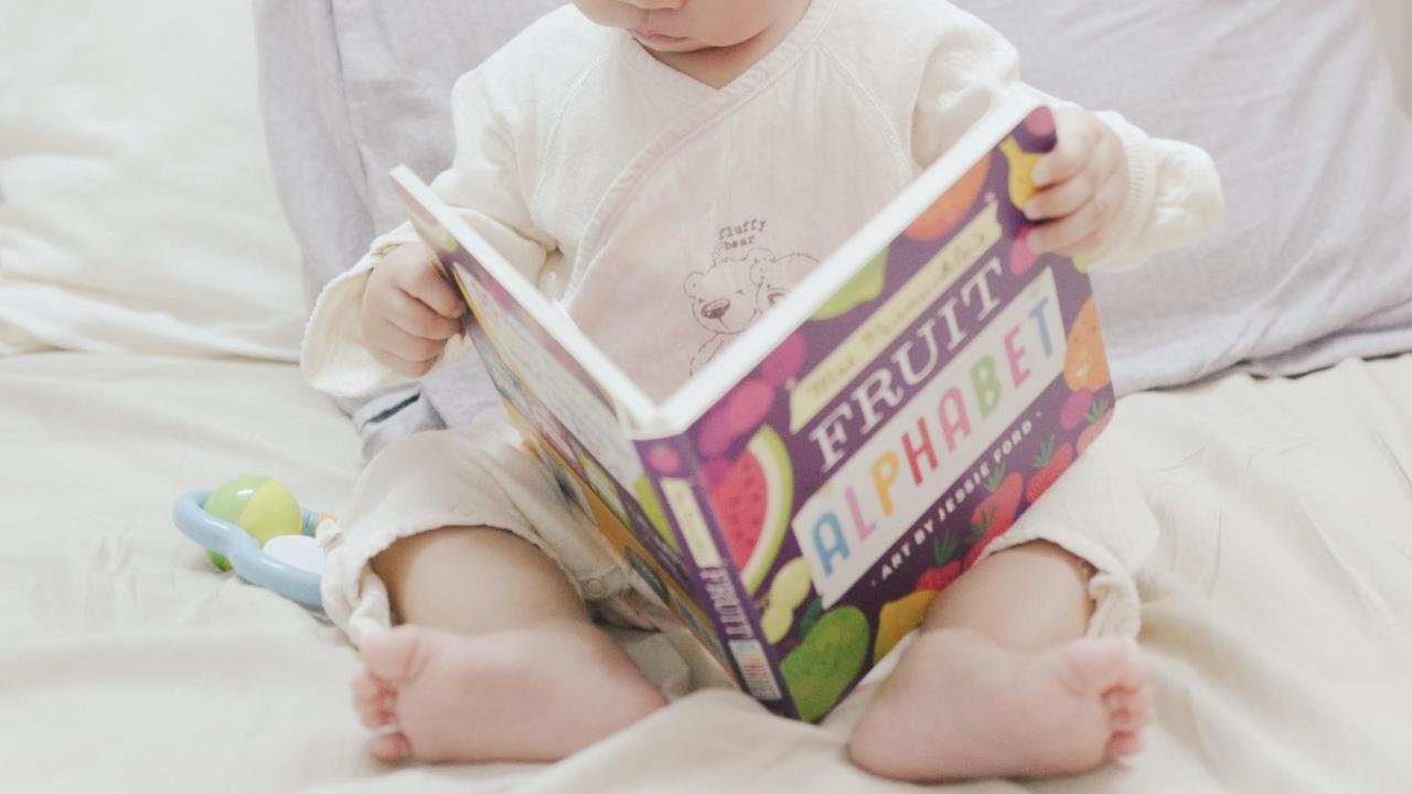 child reading a book about food