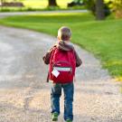 boy walking with backpack